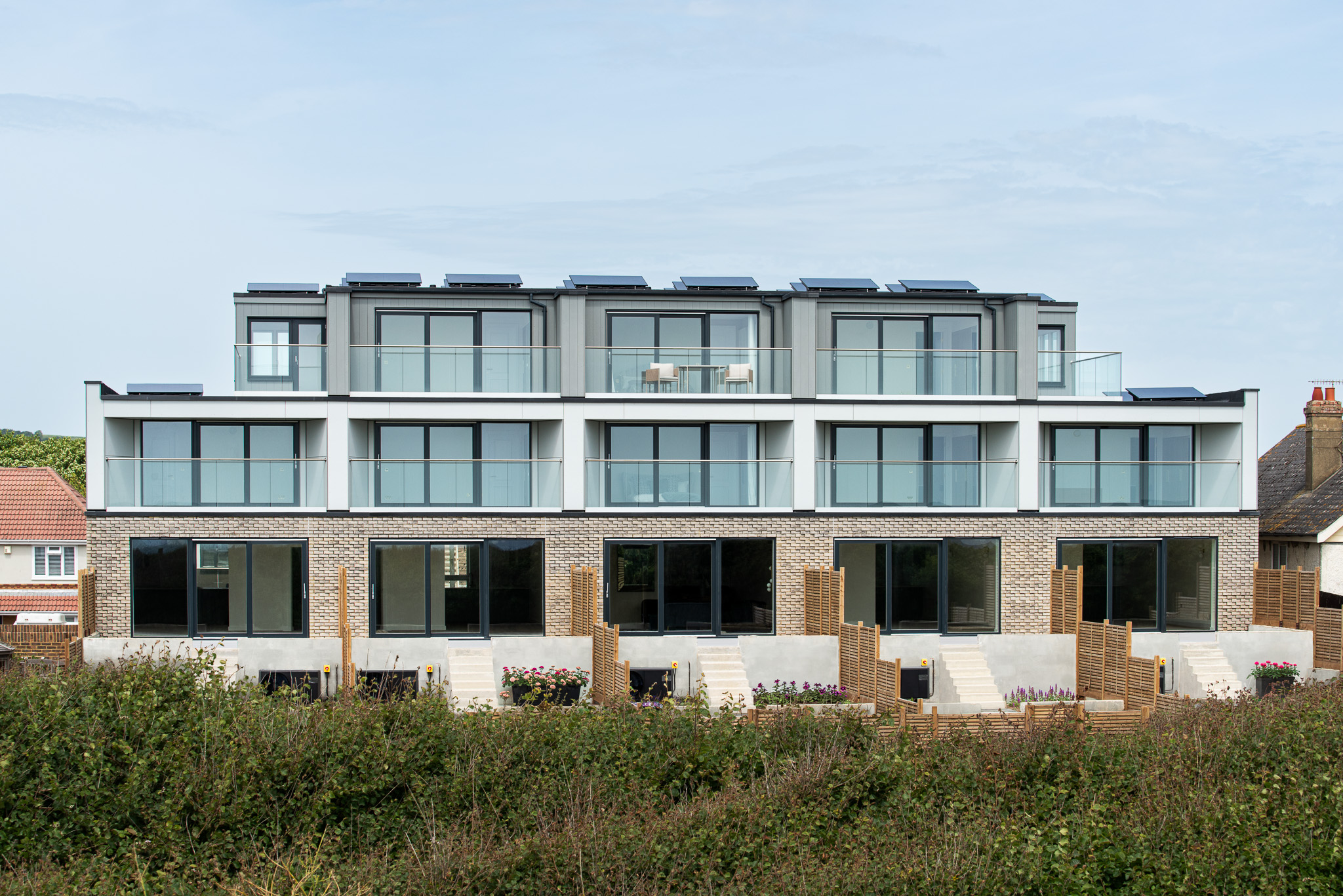 Front elevation of the Brighton Road residential building in Lancing, with inset balconies and brick lower storey