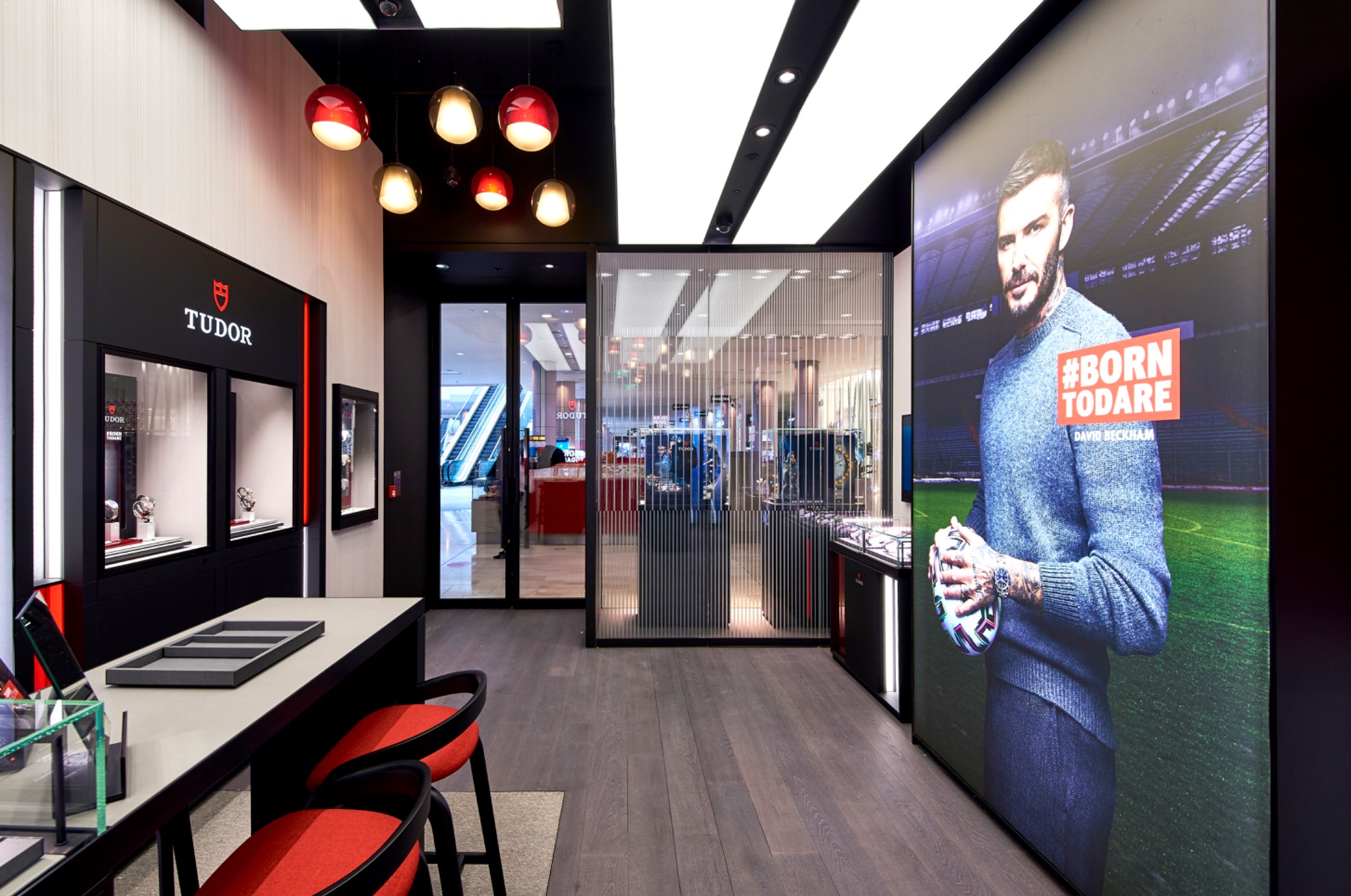 Display cases and campaign imagery within the Tudor boutique at Westfield London