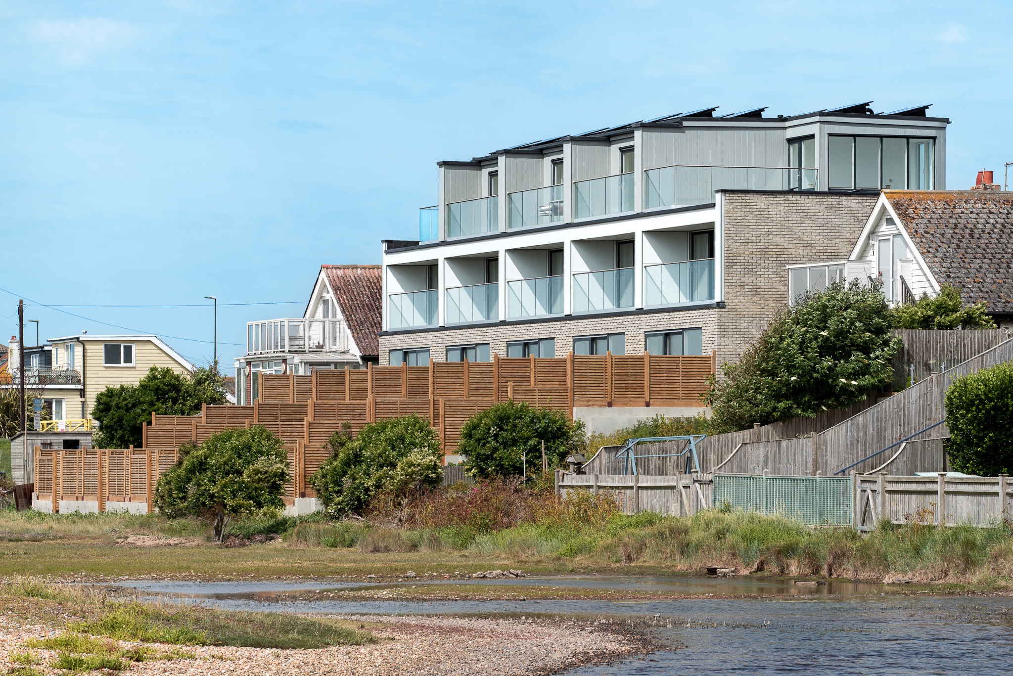 Oblique view of the Brighton Road building and neighbouring homes from the coastal landscape