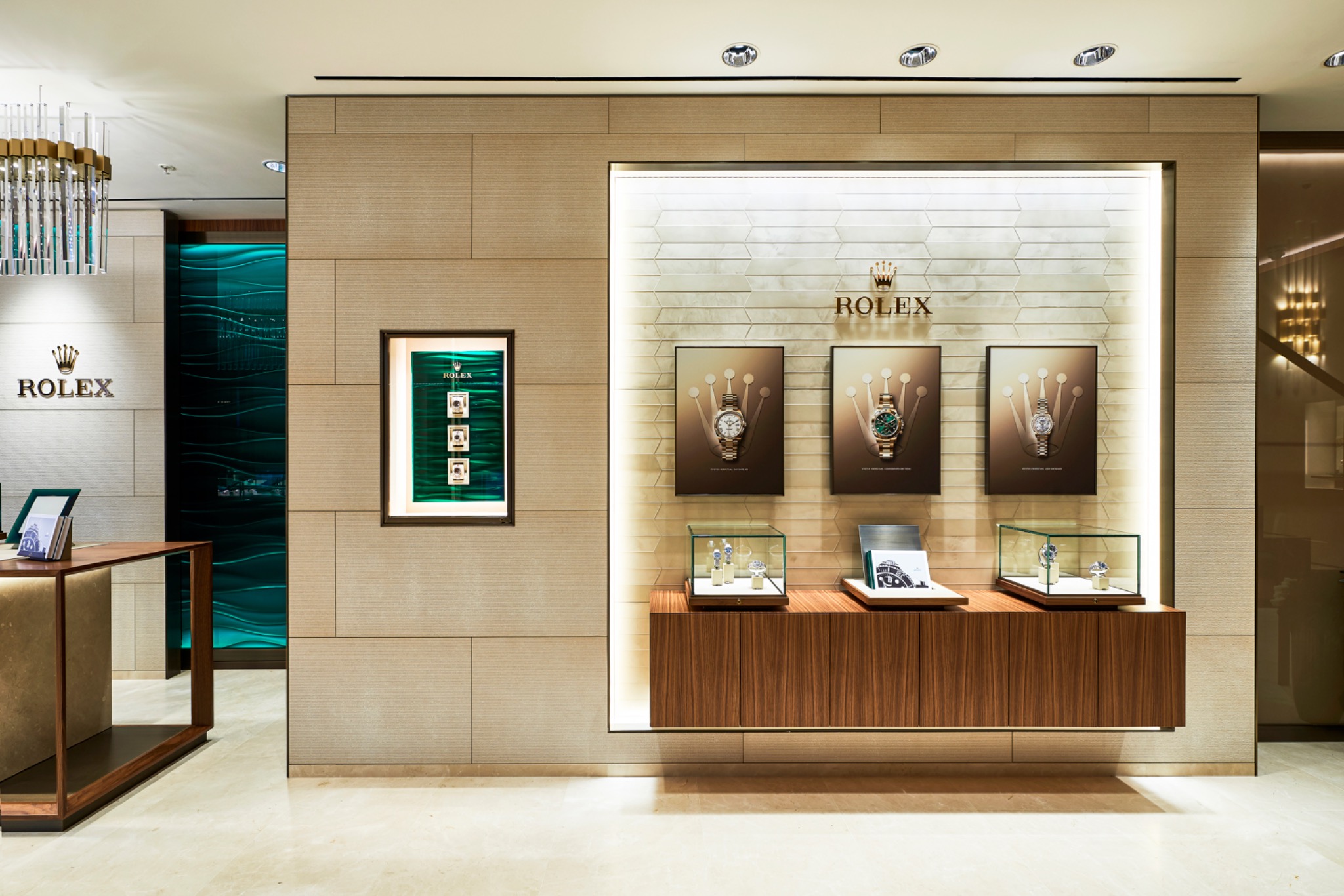 Illuminated watch display integrated into the pale stone wall of the Rolex Glasgow showroom