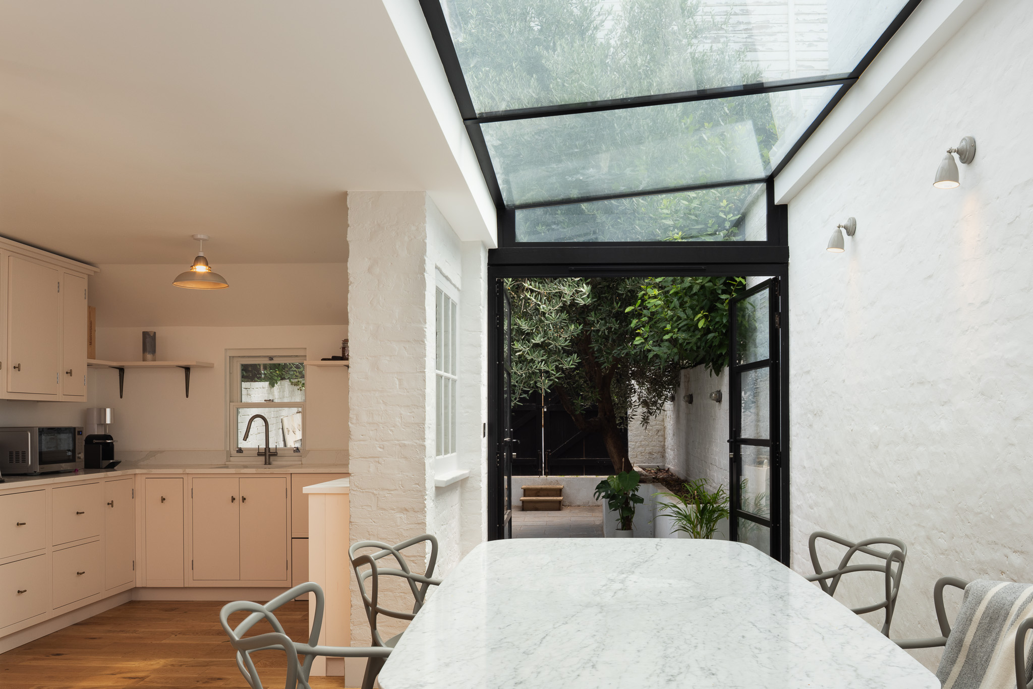Kitchen and dining room opening towards the planted courtyard at Roupell Street, London