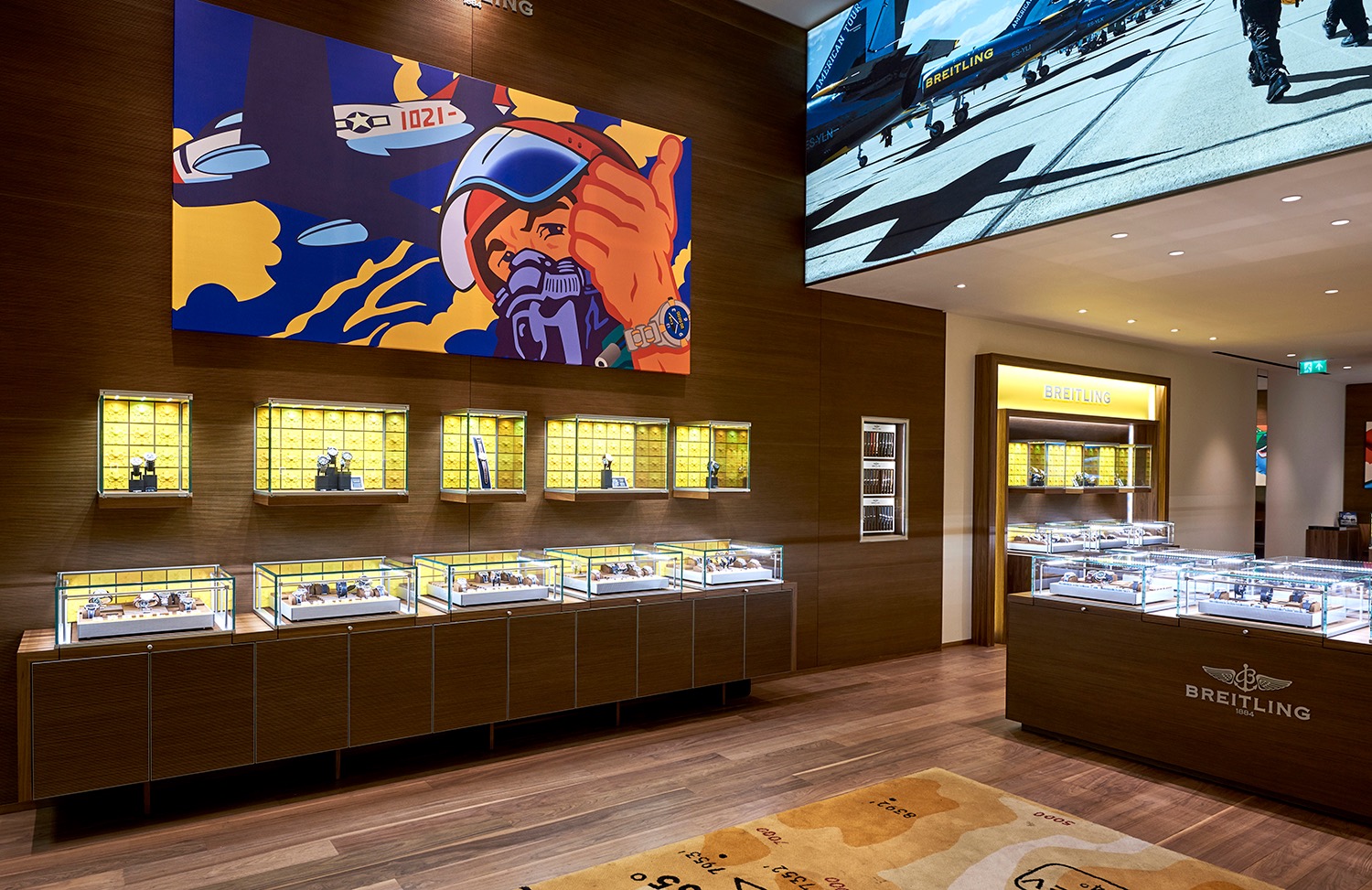 Breitling interior with illuminated displays, artwork and a large overhead screen