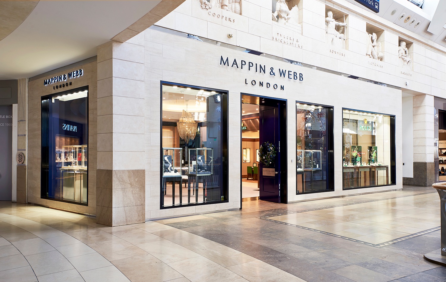 Mappin and Webb shopfront set into a pale stone shopping-centre elevation