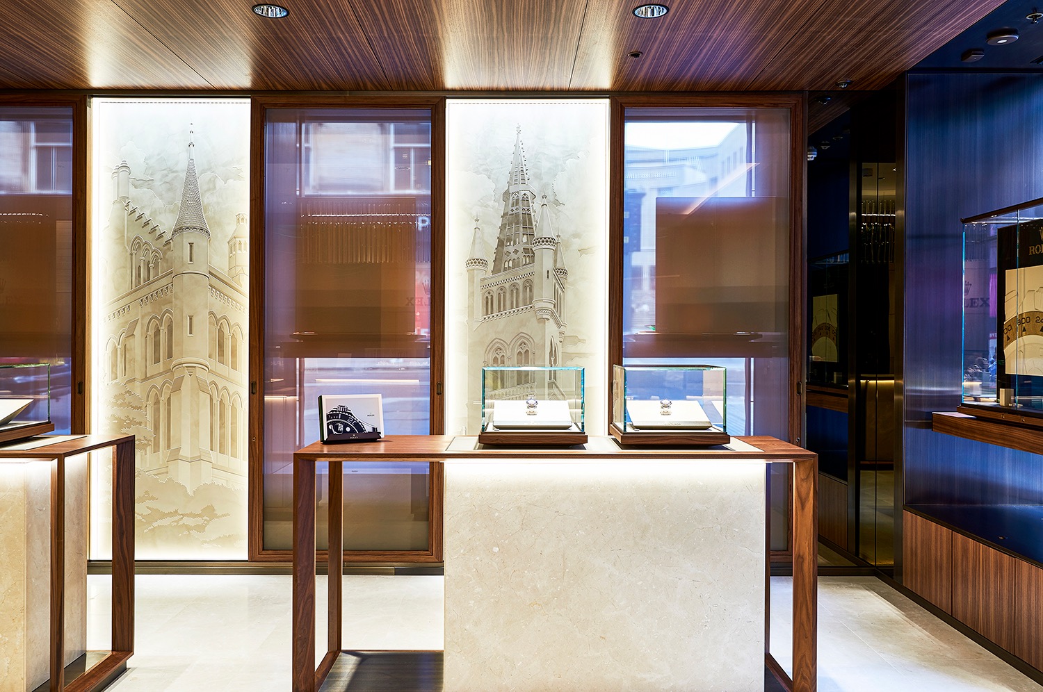 Rolex interior with display cases and historic Glasgow architecture visible through the windows