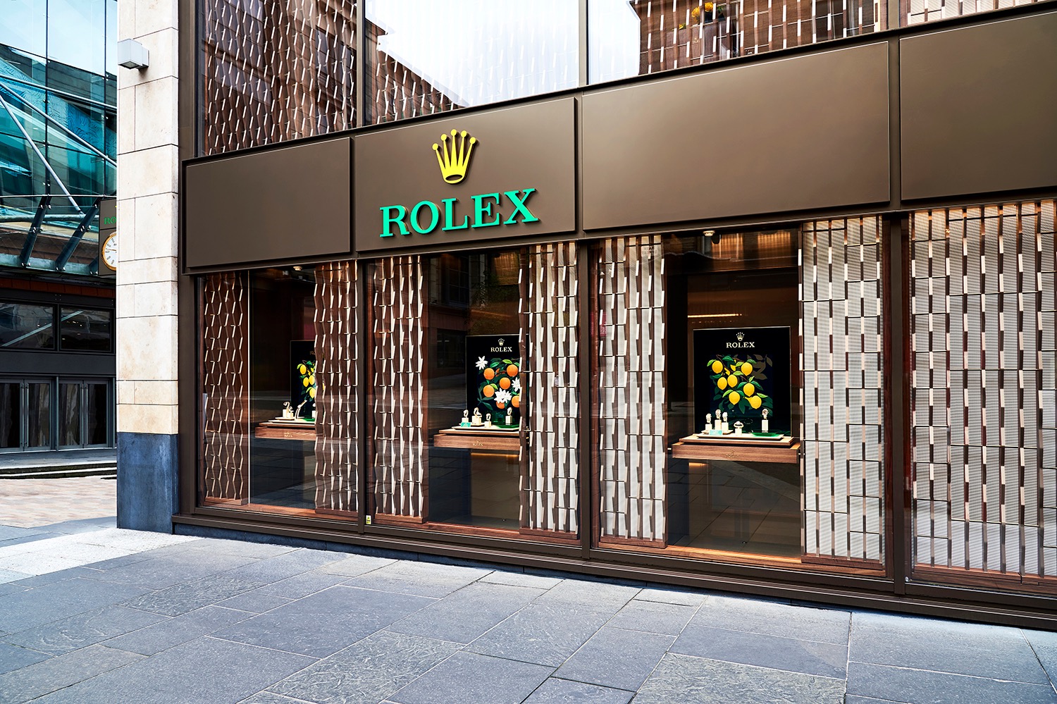 Rolex frontage with a patterned bronze screen and recessed windows