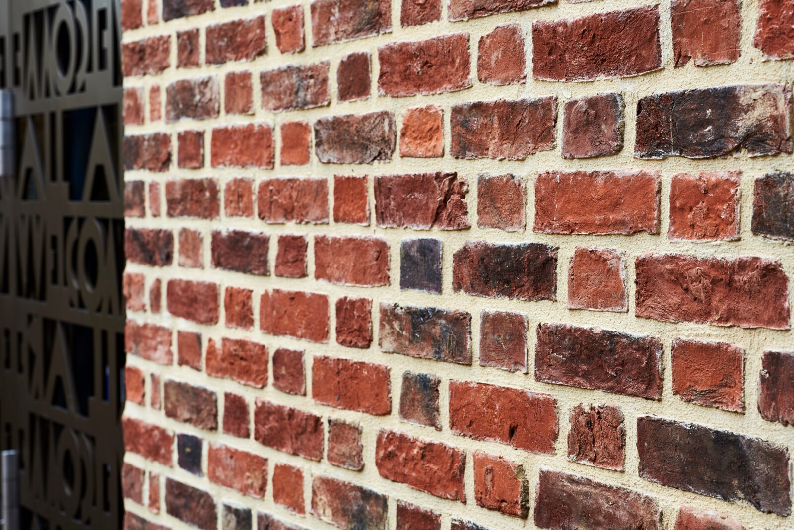 Close view of varied red brick and pale mortar in the new church extension