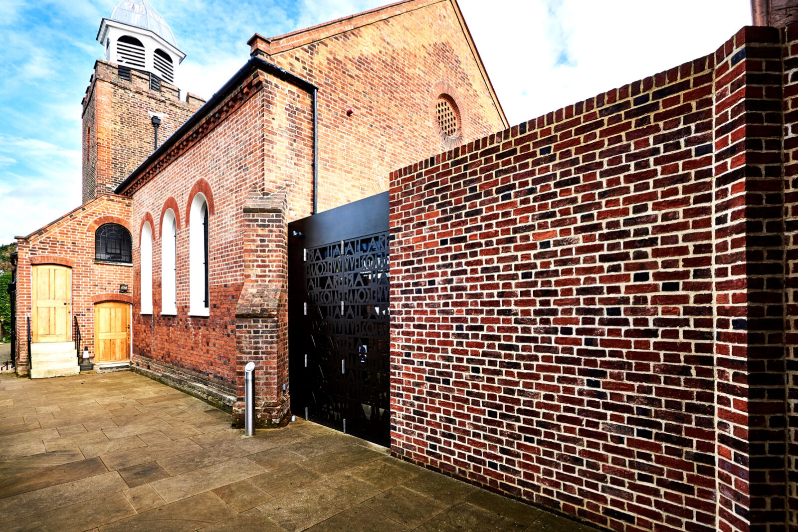 New brick wall and screen aligned with the existing church elevation