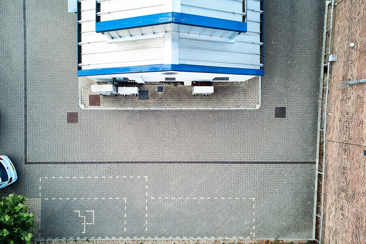 Aerial view of heat-pump equipment beside the manufacturing building
